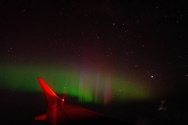 istock Aurora borealis and stars seen from a plane window in the silent dark sky 2210180941