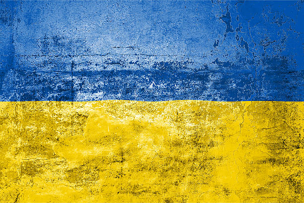 istock Ukraine State Flag. Dirty Ukraine state flag on the wall. 2210181981