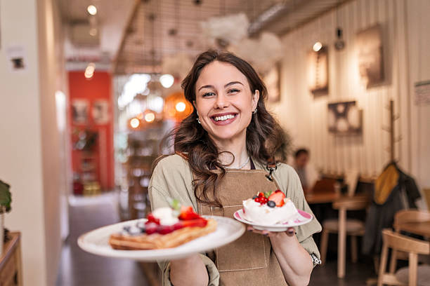 Smiling Waitress Serving Freshly Made Cakes in Trendy Café