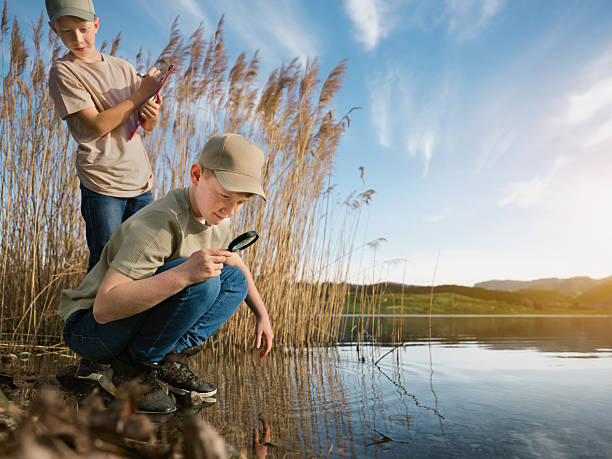 istock Young boys exploring nature on the lakeshore. 2210183263