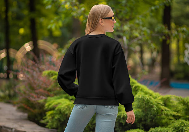 istock Black sweatshirt mockup on beautiful girl, back view, for design, print, pattern, branding, presentation on park background, outdoor. 2210188314