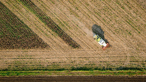 istock Aerial view on combine, harvester machine, harvest ripe maize 2210192181
