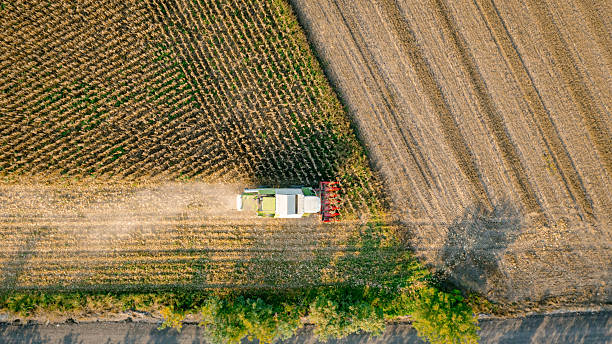 istock Aerial view on combine, harvester machine, harvest ripe maize 2210192846