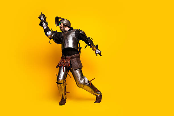istock Knight in Bright Armor Striking a Bold Pose Against a Yellow Backdrop 2210193135