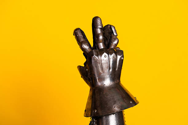 Medieval Armor Glove Against Bright Yellow Background Captures Historical Charm