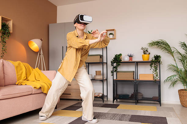 istock Woman using a VR headset at home 2210193248