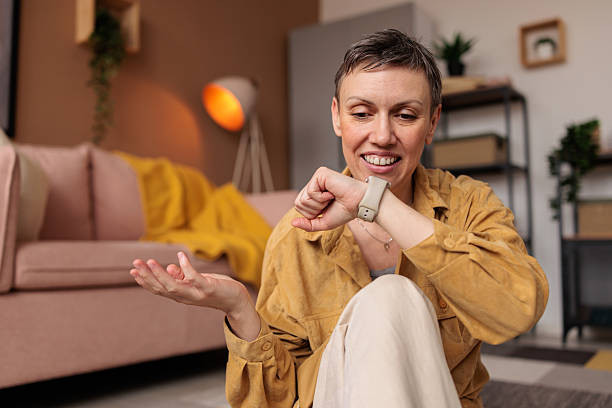 istock Woman talking on her smart watch at home 2210193269