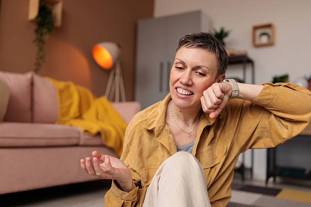 istock Woman talking on her smart watch at home 2210193278