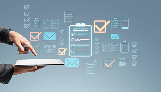 istock Businessperson using digital tablet with floating icons for checklist, messages, and data management on light blue background conceptually visualized. 2210193327