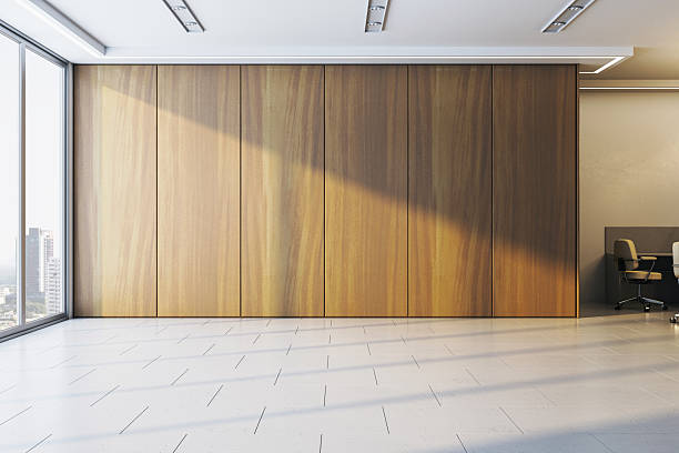 istock Blank wooden wall in modern office interior with sunlight casting shadows on white tiled floor in bright empty room space for clean presentation.. 3D Rendering 2210193434
