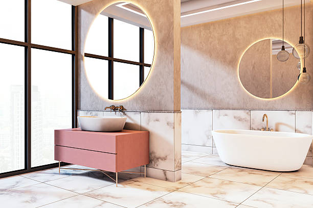 istock Elegant modern bathroom interior with marble surfaces, round mirrors, city view windows, and stylish bathtub and sink furniture design.. 3D Rendering 2210193668