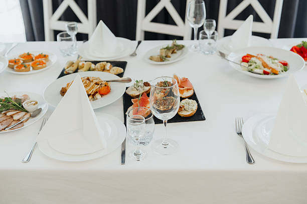 istock Elegant dining table set with gourmet dishes in a bright setting 2210197471
