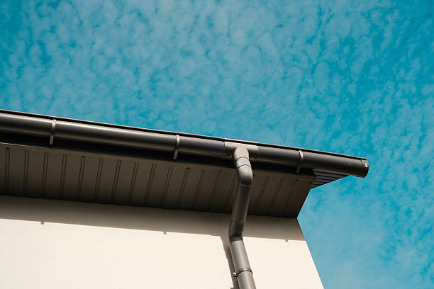 istock Modern building roof against a bright blue sky with clouds 2210197475