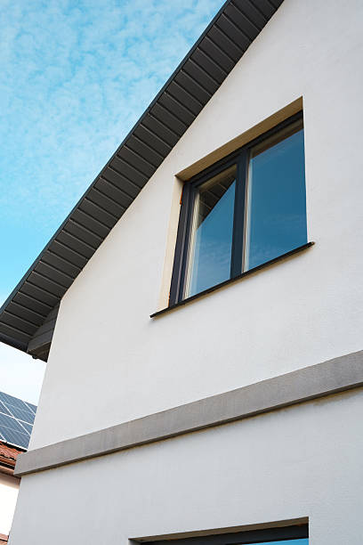 istock Modern house exterior with large window and solar panels on roof 2210197609