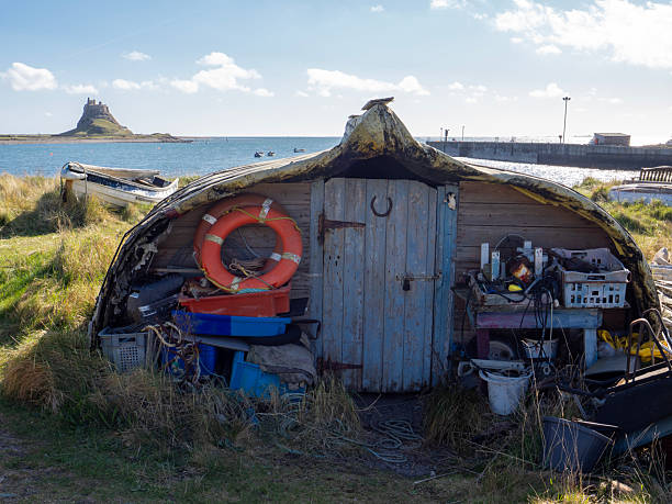 Old upturned boat being used as a shed on Holy Isle, Northumberland.