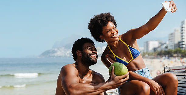 istock Happy couple taking a beach selfie during holiday in Brazil 2210200041