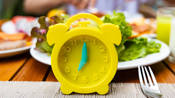 istock Alarm clock with IF (Intermittent Fasting) 16 and 8 diet rule and weight loss concept.-Diet plan concept 2210200085