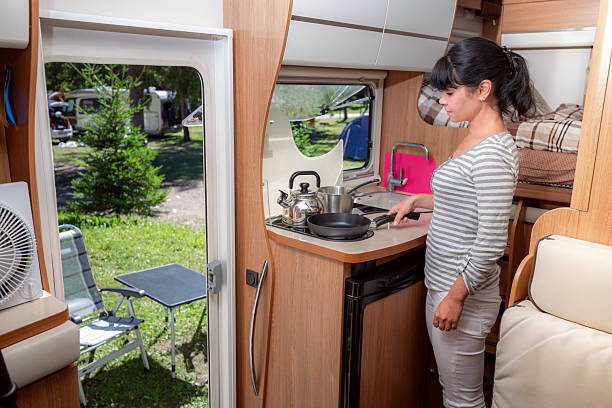 istock Woman cooking in camper, motorhome interior RV 2210202683