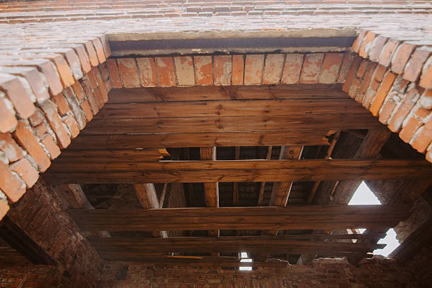 istock Damaged ceiling and floor in an abandoned red brick house – structural decay, danger, and urban exploration atmosphere 2210204483