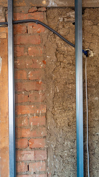 istock Metal profile frame for an old wall with electronic wire. Brick wall with clay with profile frame 2210207470