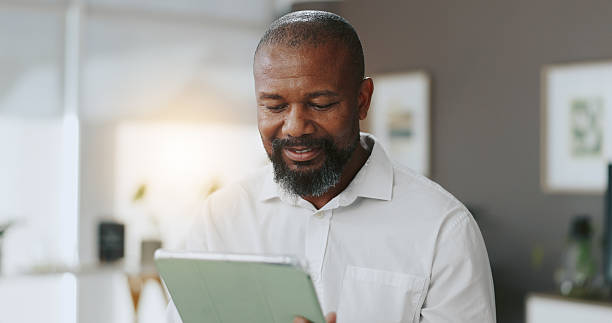 istock Tablet, planning and reading with business black man in office for research, client feedback and idea. Smile, project progress and update with person in creative agency for online review and report 2210207949