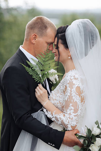 istock A bride and groom are hugging each other with a white veil on the bride's head 2210208214