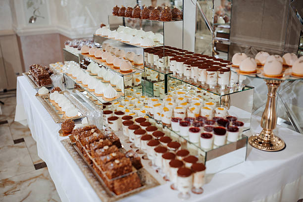 istock A table full of desserts and pastries, including cakes, cupcakes 2210208219