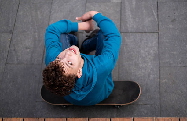 istock the boy takes a break from skating 2210208330