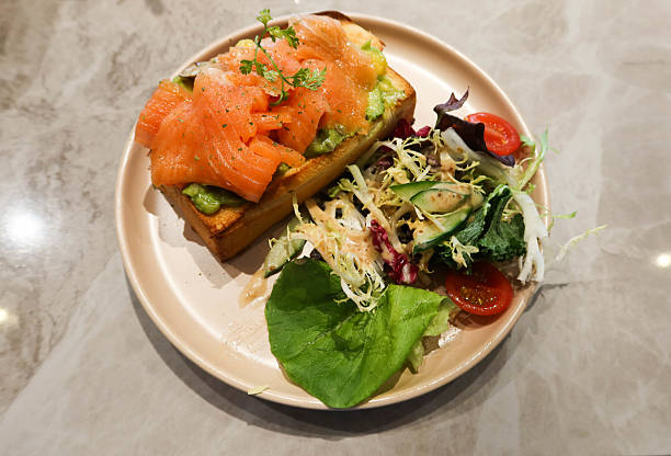 istock avocado salmon toast with salad on the side 2210210357
