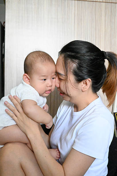 istock Mother looking at the baby's face 2210211483