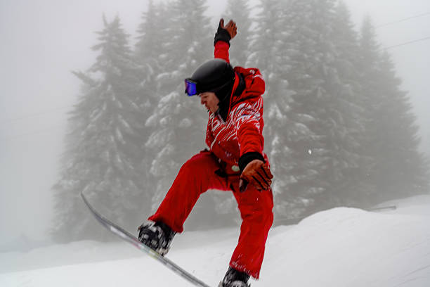 istock Snowboarder Performing an Aerial Trick on a Winter Mountain 2210212506