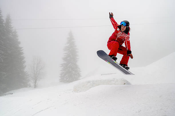 istock Exciting snowboarding jump in action during a winter mountain scene 2210212589