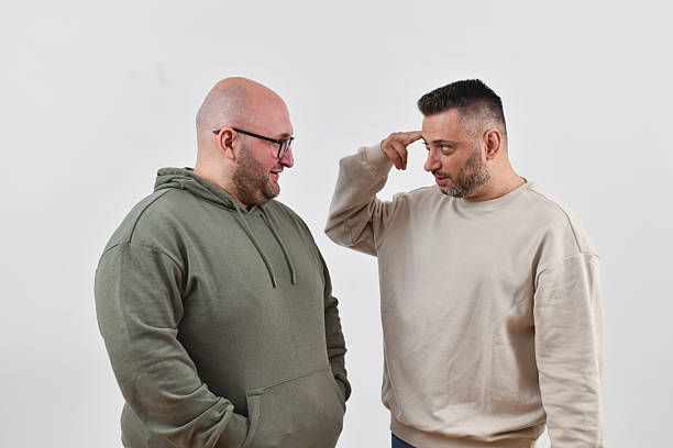 Male Gesturing With Hands While Explaining Last Night's Story to Friend
