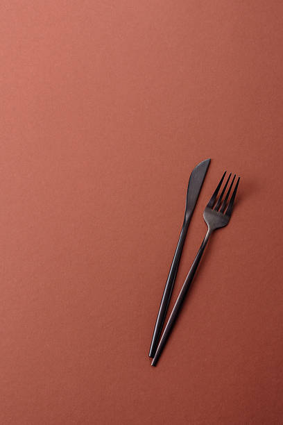 istock Knife and fork, cutlery on a brown dining table 2210217260