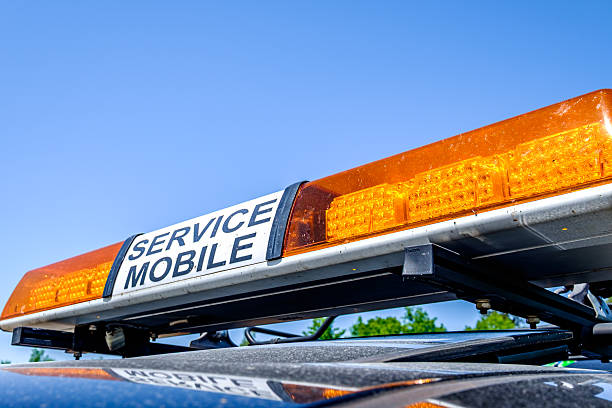 istock Service mobile alert light mounted on a vehicle under clear blue sky, indicating readiness for quick response in urban setting 2210217328