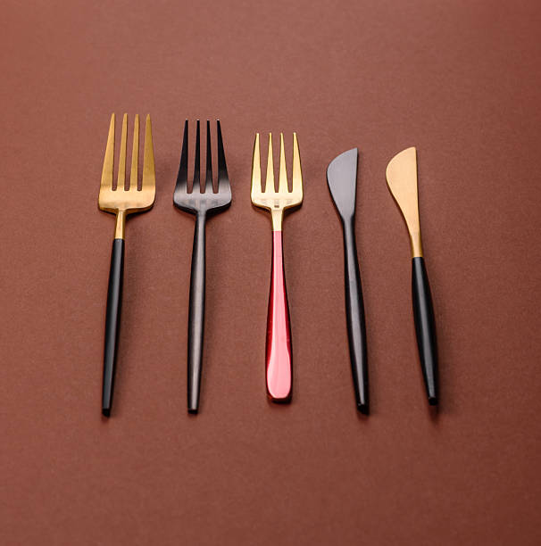 istock Knife and fork, cutlery on a brown dining table 2210218021
