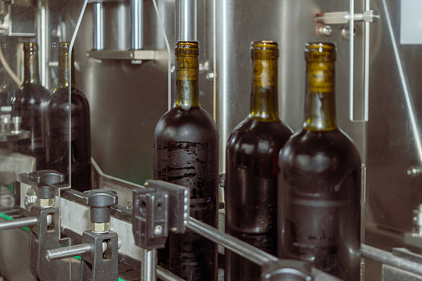 istock Wine bottles on a production line at a modern winery, showing automated bottling process in industrial environment. 2210218369