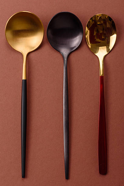 istock Empty metal spoon on a monochrome brown background 2210218410