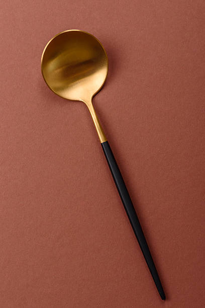 istock Empty metal spoon on a monochrome brown background 2210218590