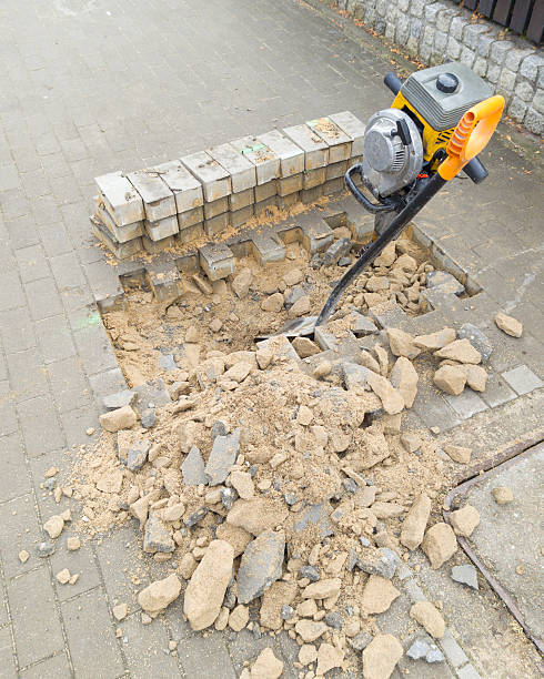 istock Sidewalk Repair with Jackhammer and Bricks 2210221490