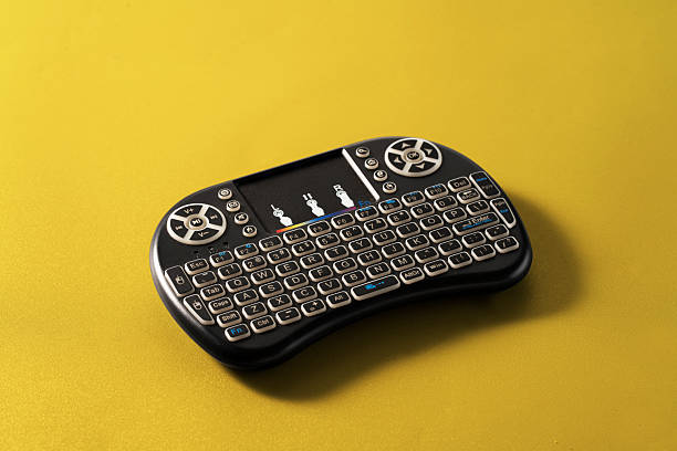 A remote control in the form of a keyboard on yellow background