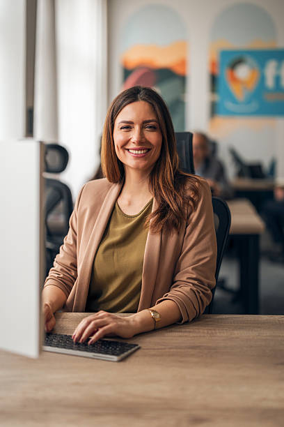 istock Professional Businesswoman Smiling at Modern Office Workspace 2210224115