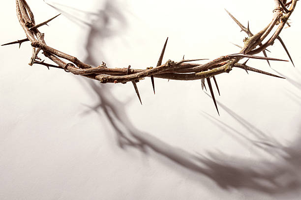 istock Jesus Crown of thorns casting a distinct shadow on a for Christian background, Easter concept creating a symbolic image of suffering, sacrifice, and remembrance Copy space for text 2210225170