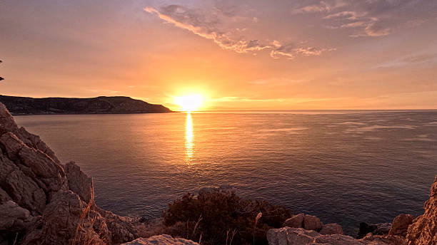 istock Sunrise over calm bay 2210225183
