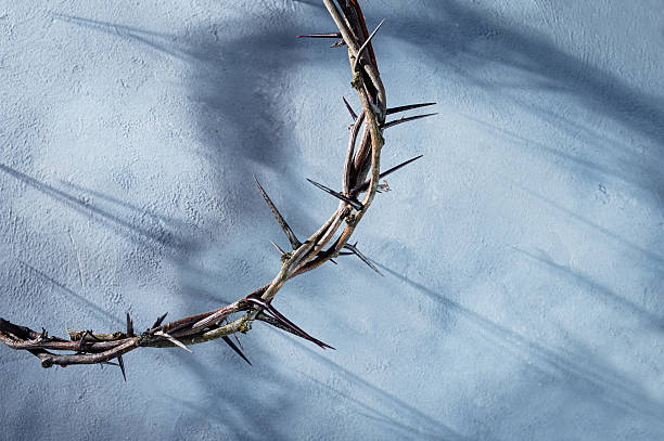 istock Jesus Crown of thorns projecting shadowy silhouette against textured gray surface, symbol spiritual pain and redemptive struggle Banner good friday for Christian background, Easter concept 2210225201