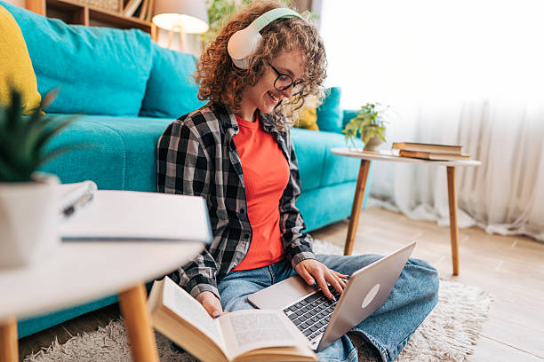 istock Young student studying with laptop and book at home 2210225339