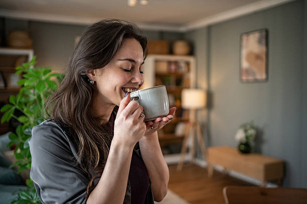 istock Young woman enjoying a hot beverage at home 2210225593