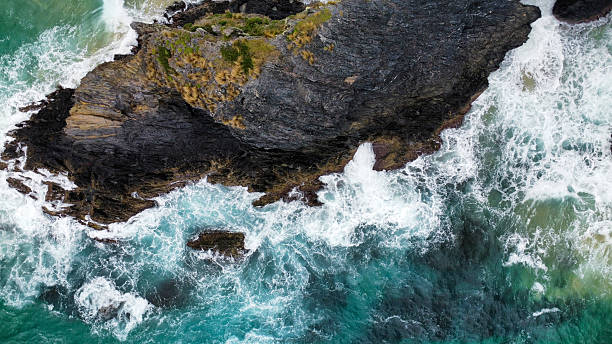 istock Rocks off the coast in rough seas, seen from above 2210230488