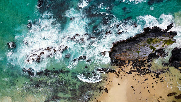 istock Rocks off the coast in rough seas, seen from above 2210231236