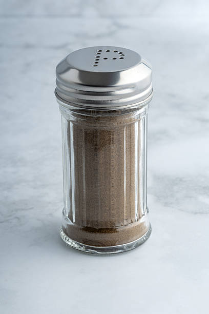 istock Pepper shaker with metal lid on marble surface 2210232110